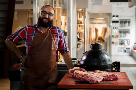 Cheefrul chef with raw beef steakes in a restaurantの写真素材
