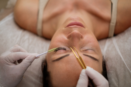 Procedure of eyelash extension in salon by cosmeticianの写真素材