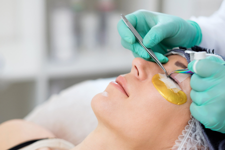 Procedure of eyelash extension in salon by cosmeticianの写真素材