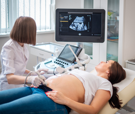 Pregnant woman on utltrasonographic examination at hospitalの写真素材