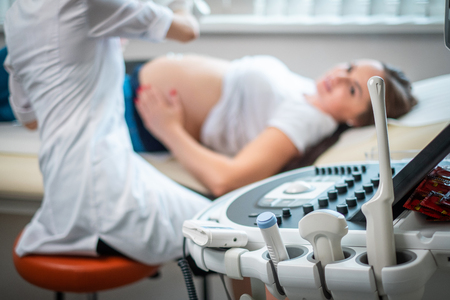 Pregnant woman on utltrasonographic examination at hospitalの写真素材