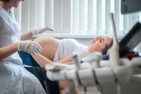 Pregnant woman on utltrasonographic examination at hospitalの写真素材