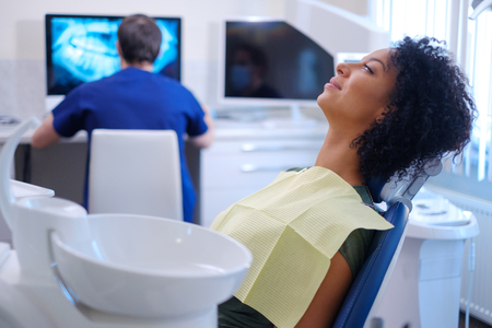 Man dentist works on a x-rayの写真素材