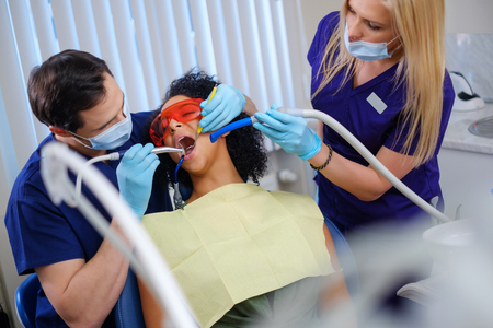 Dentist and his assitant working in private practiceの写真素材