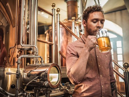 Man tasting fresh beer in a breweryの写真素材