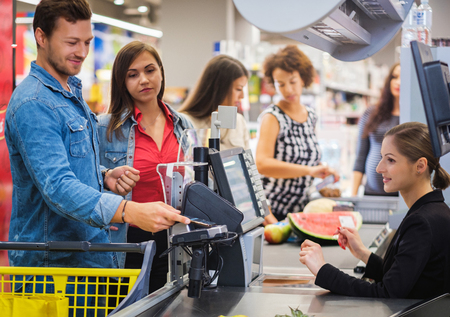 Man paying with NFC in a grocery storeの写真素材