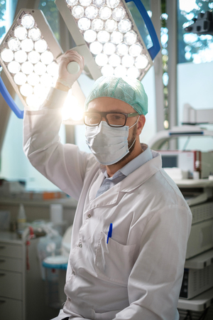 Male asian surgeon in operation room with his teamの写真素材