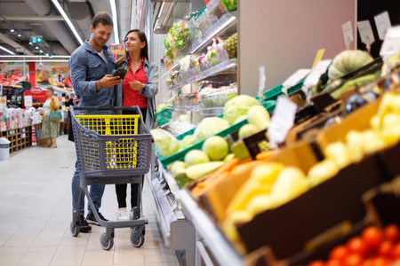 Young couple choosing goods in a grocery storeの写真素材