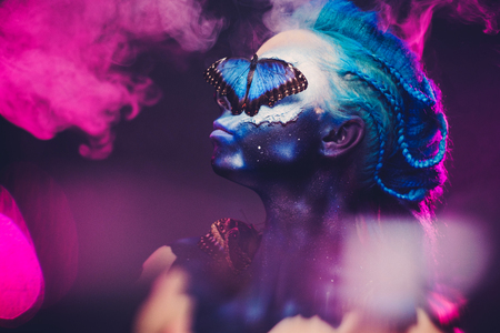 Beautiful woman with blue hair and butterflyの写真素材