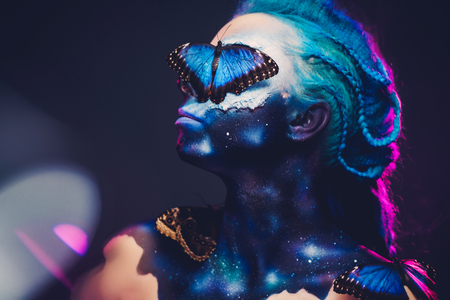 Beautiful woman with blue hair and butterflyの写真素材