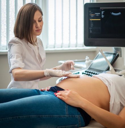 Pregnant woman on utltrasonographic examination at hospitalの写真素材