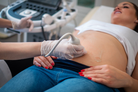Pregnant woman on utltrasonographic examination at hospitalの写真素材