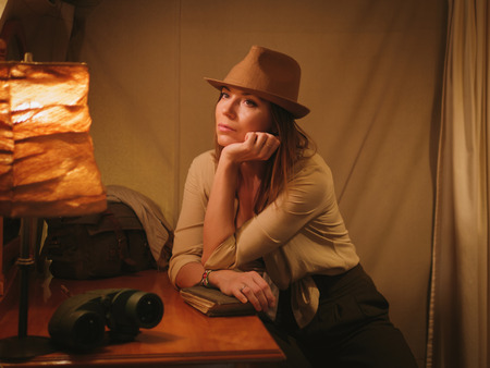 Beautiful woman in a tent at savanna, Kenyaの写真素材