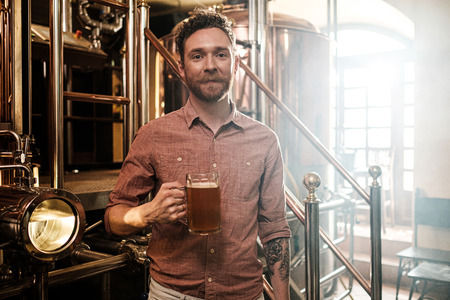 Man tasting fresh beer in a brewery