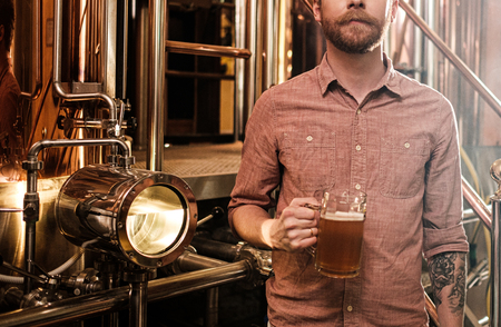 Man tasting fresh beer in a breweryの写真素材