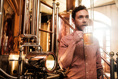 Man tasting fresh beer in a breweryの写真素材