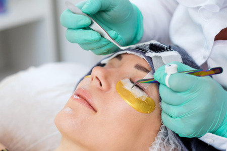 Procedure of eyelash extension in salon by cosmeticianの写真素材