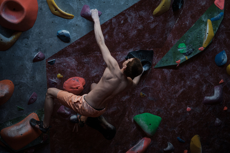 Athletic woman practicing in a bouldering gymの写真素材