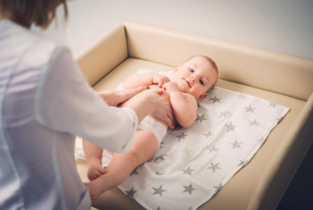 Baby boy getting a massage from masseuseの写真素材