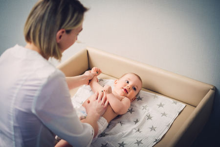 Baby boy getting a massage from masseuseの写真素材