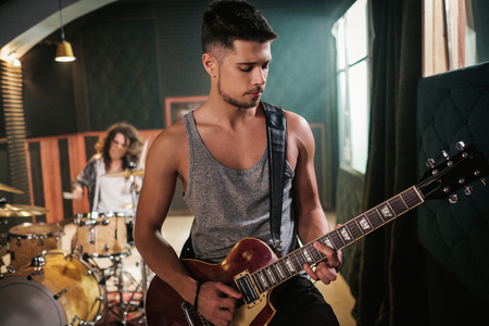 Music band having rehearsal in a studioの写真素材