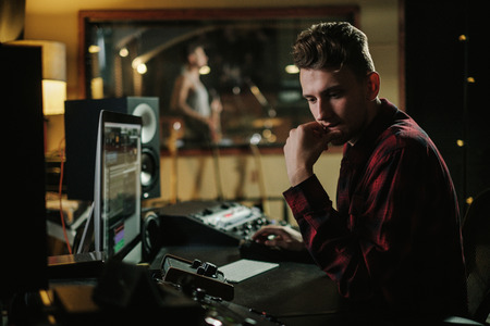 Sound engineer working in a music studioの写真素材