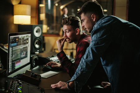Sound engineer working in a music studioの写真素材