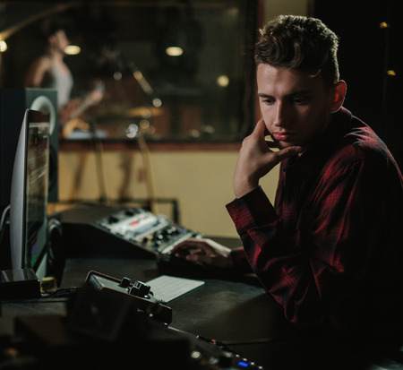 Sound engineer working in a music studioの写真素材