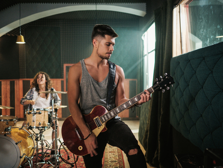 Music band having rehearsal in a studioの写真素材
