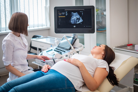Pregnant woman on utltrasonographic examination at hospitalの写真素材