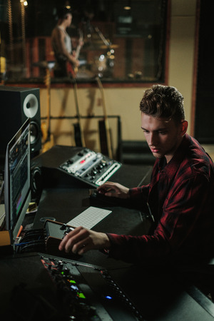 Sound engineer working in a music studioの写真素材