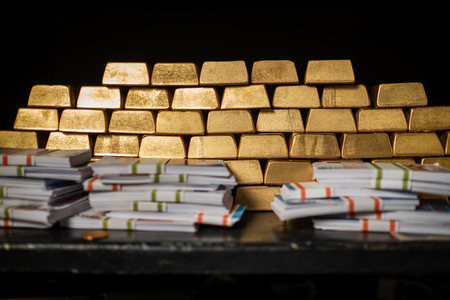 Bank vault with gold and cashの写真素材