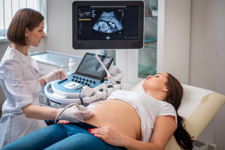 Pregnant woman on utltrasonographic examination at hospitalの写真素材