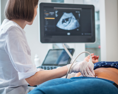 Pregnant woman on utltrasonographic examination at hospitalの写真素材