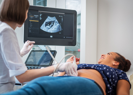 Pregnant woman on utltrasonographic examination at hospitalの写真素材