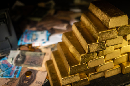 Bank vault with gold and cashの写真素材