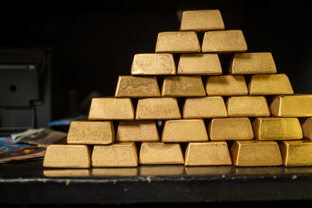Bank vault with gold and cashの写真素材
