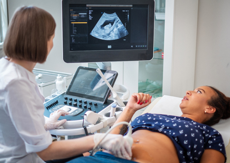 Pregnant woman on utltrasonographic examination at hospitalの写真素材