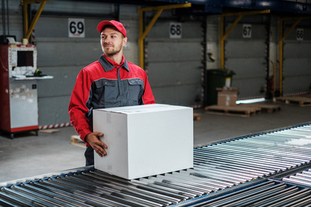 Warehouse worker working on a conveyor lineの写真素材