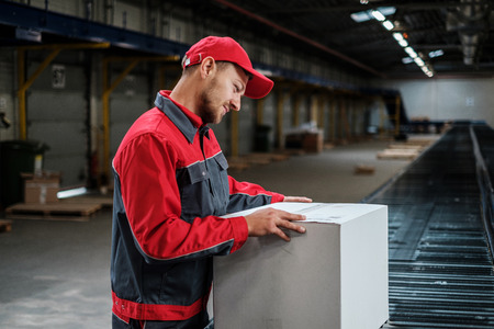 Warehouse worker working on a conveyor lineの写真素材