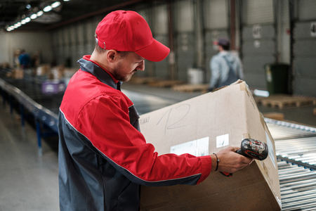 Warehouse worker working on a conveyor lineの写真素材
