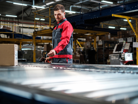 Warehouse worker working on a conveyor lineの写真素材