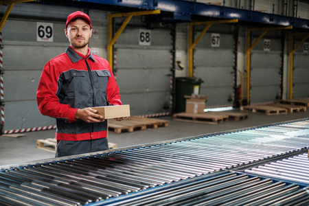 Warehouse worker working on a conveyor lineの写真素材