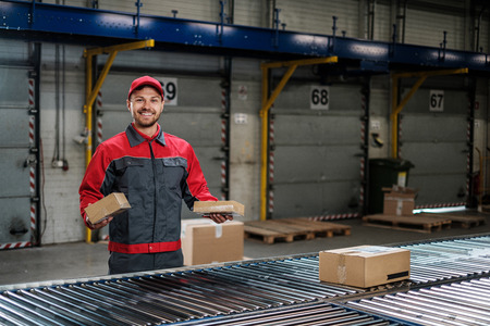 Warehouse worker working on a conveyor lineの写真素材