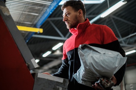 Courier picks up package on a warehouseの写真素材