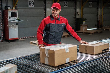 Warehouse worker working on a conveyor lineの写真素材