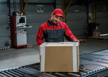 Warehouse worker working on a conveyor lineの写真素材