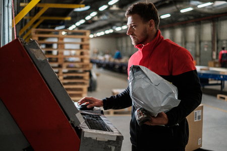 Courier picks up package on a warehouseの写真素材