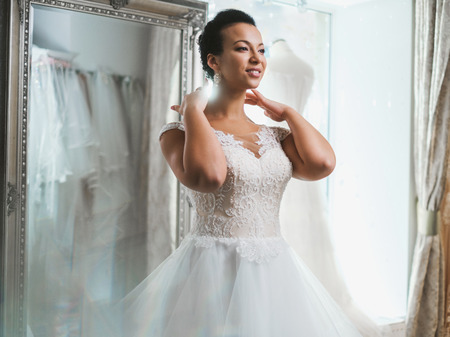 Beautifu bride choosing wedding dress in a wedding salonの写真素材