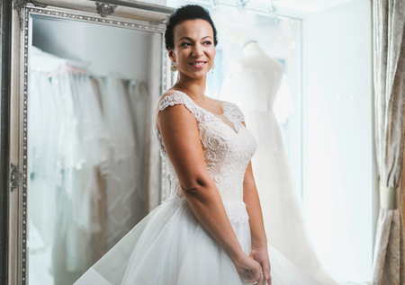 Beautifu bride choosing wedding dress in a wedding salonの写真素材